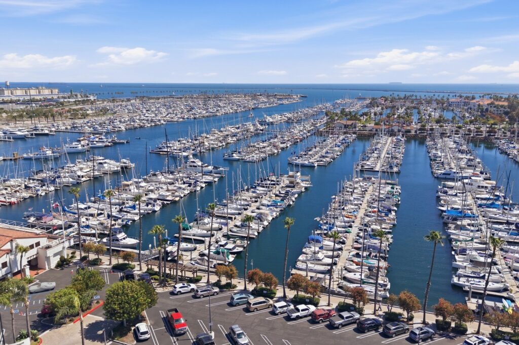 Aerial overview of Long Beach Marina with boats, palm trees, and the Pacific Ocean